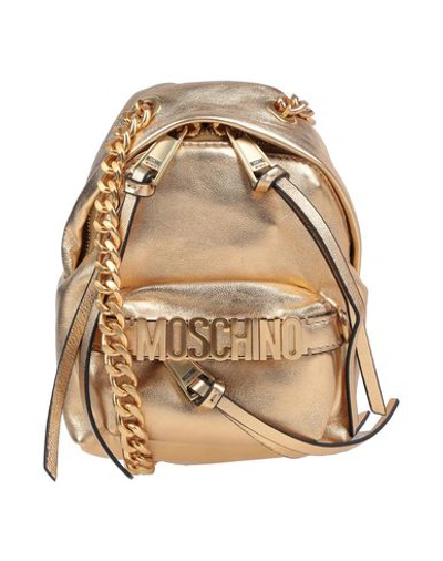Shop Moschino Cross-body Bags In Gold