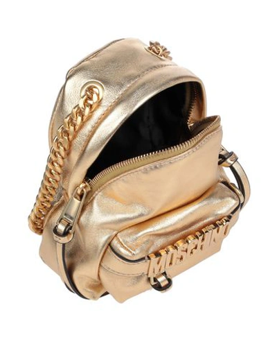 Shop Moschino Cross-body Bags In Gold