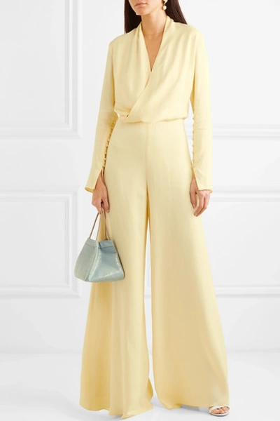 Shop Les Hã©roã¯nes The Tina Wrap-effect Satin Jumpsuit In Pastel Yellow