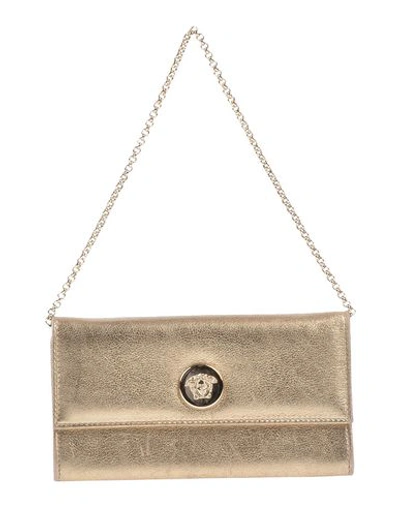 Shop Versace Handbag In Gold