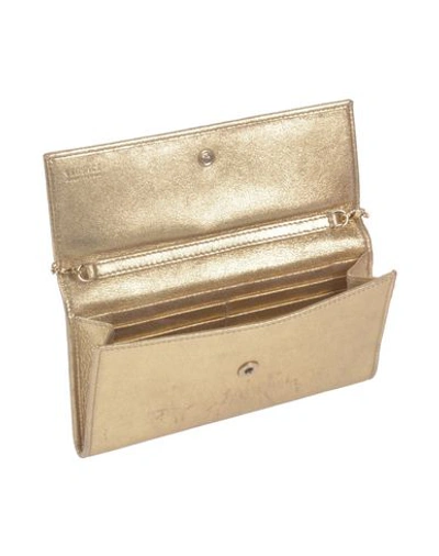 Shop Versace Handbag In Gold