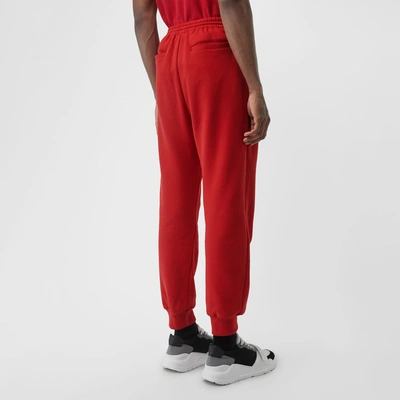 Shop Burberry Chequer Ekd Cotton Trackpants In Military Red