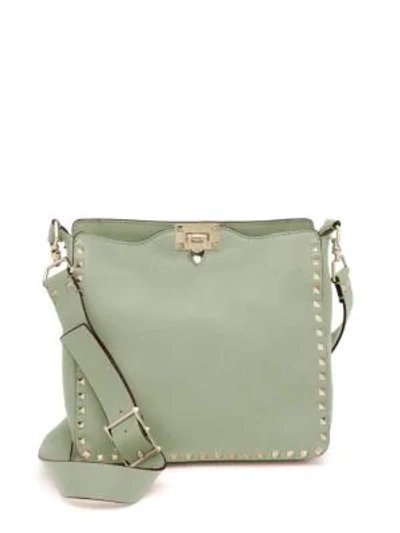 Shop Valentino Rockstud Small Leather Hobo Bag In Indaco