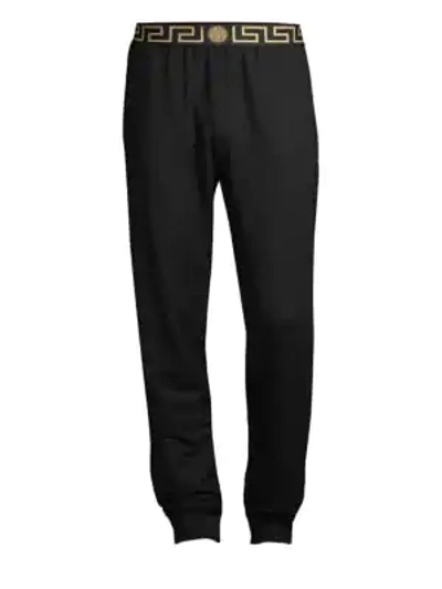 Shop Versace Greca Border Gym Trousers In Black Gold