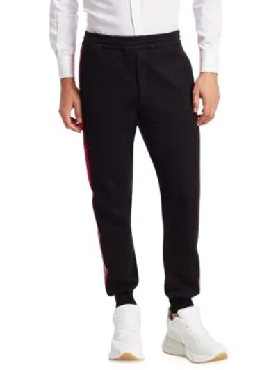 Shop Alexander Mcqueen Side-stripe Jogger Pants In Black Red