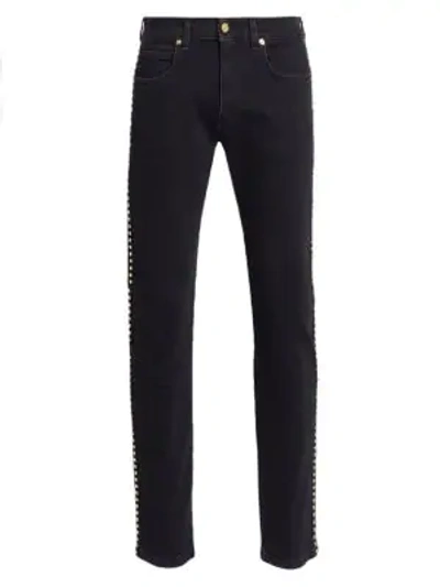 Shop Versace Studded-side Skinny Jeans In Black