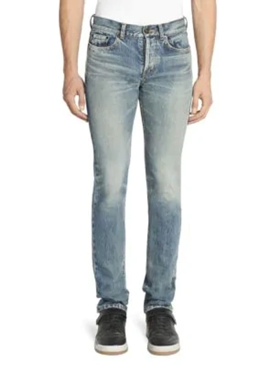 Shop Saint Laurent Slim-fit Raw Edge Jeans In Blue