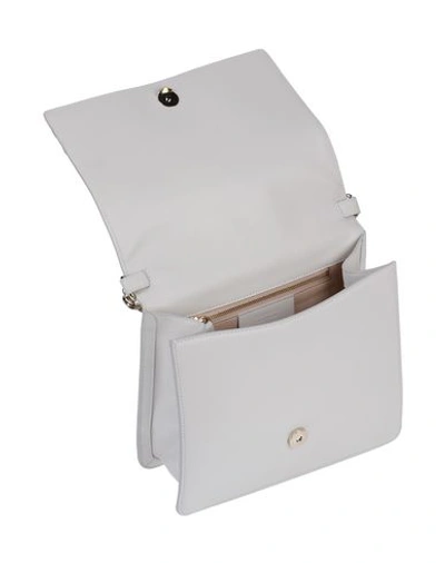 Shop Roberto Cavalli Cross-body Bags In White