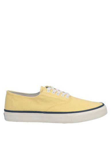 yellow sperry sneakers
