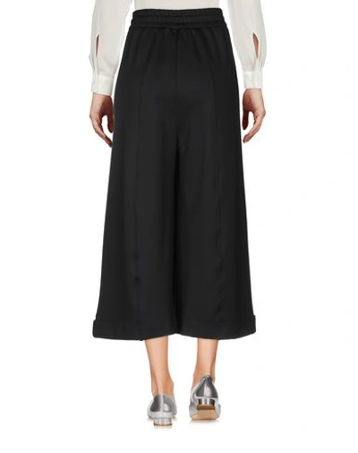 Shop Versace Cropped Pants & Culottes In Black