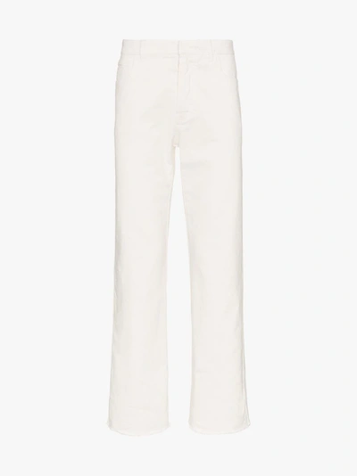 Shop Haider Ackermann Raw Hem Tapered Cotton Denim Jeans In White