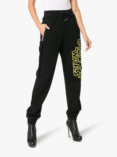 Shop Moschino Couture Wars Printed Cotton Track Pants In Black