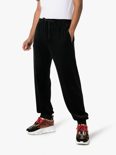 Shop Versace Logo Velour Sweatpants In Black