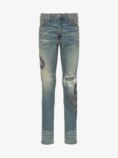 Shop Amiri Snake Embroidered Distressed Jeans In Blue