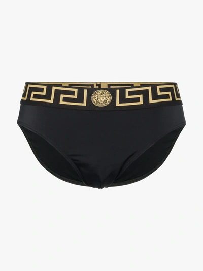 Shop Versace Greek Key Logo Swim Trunks In A80g Black Gold