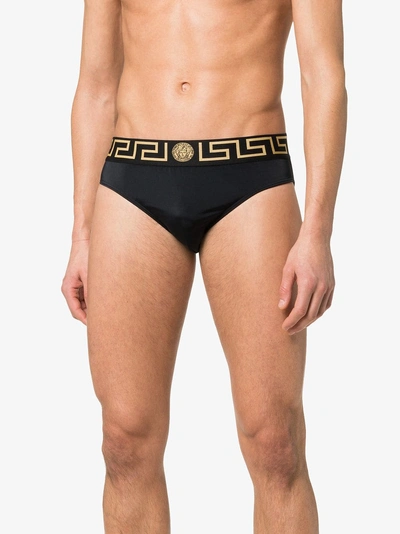 Shop Versace Greek Key Logo Swim Trunks In A80g Black Gold