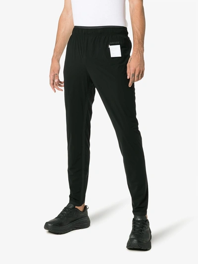 Shop Satisfy Justice Run Logo Printed Trousers In Black