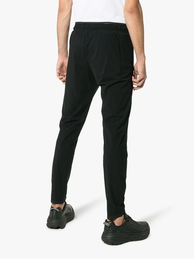 Shop Satisfy Justice Run Logo Printed Trousers In Black