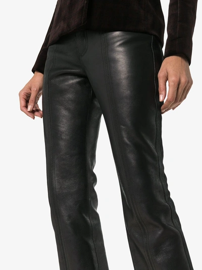 Shop Saint Laurent Kick Flare Leather Trousers In Black