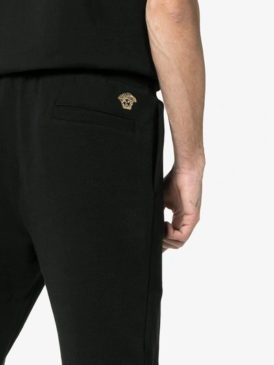 Shop Versace Embroidered Medusa Logo Cotton Sweatpants In Black