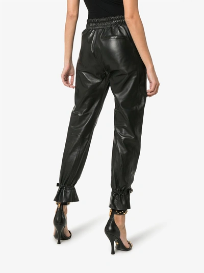 Shop Skiim Gaby High-waisted Leather Track Pants In Black