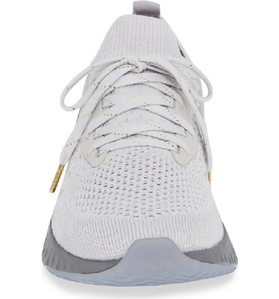 Shop Nike Epic React Flyknit Running Shoe In Grey/ Metallic Gold- Platinum