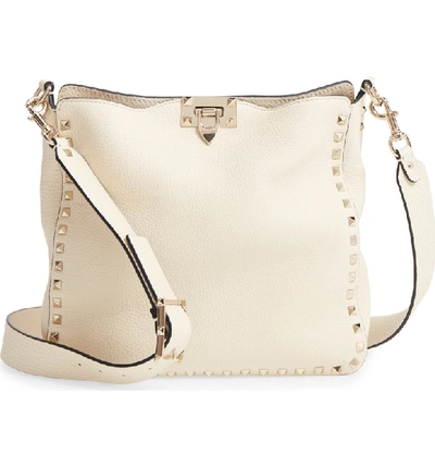 Shop Valentino Small Rockstud Leather Hobo - Ivory In Ivory/ Gold
