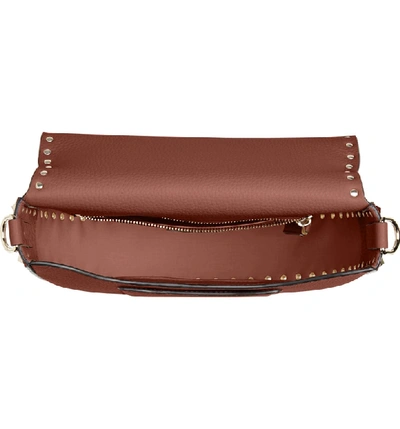 Shop Valentino Rockstud Leather Saddle Bag - Brown In Bright Cognac