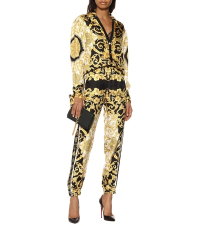 Shop Versace Printed Silk Twill Trackpants In Black