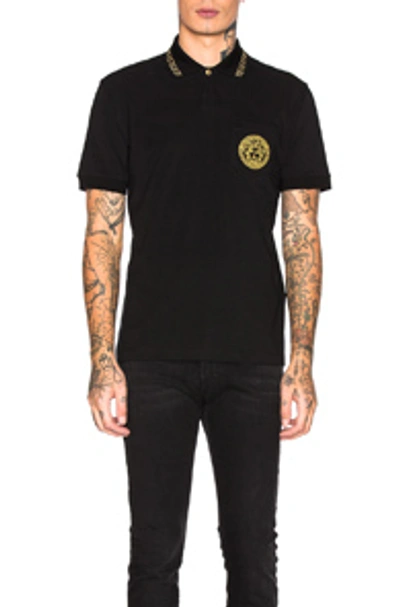 Shop Versace Polo In Black & Gold