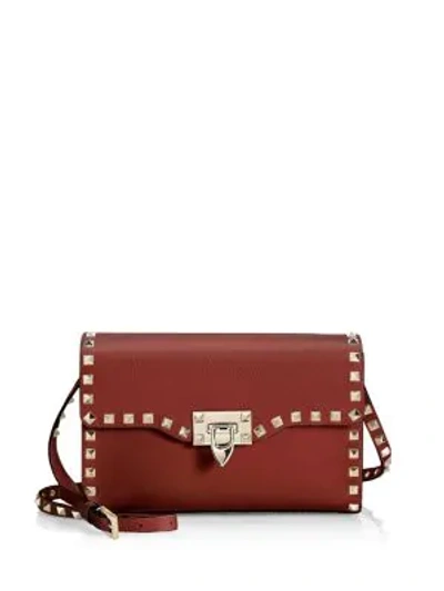 Shop Valentino Small Rockstud Leather Crossbody Bag In Red