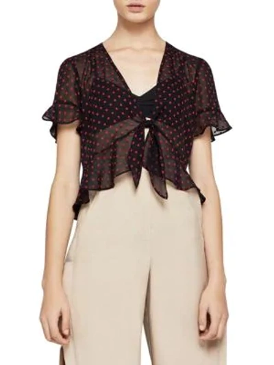Shop Bcbgeneration Tie-front Dot Ruffled Top In Black