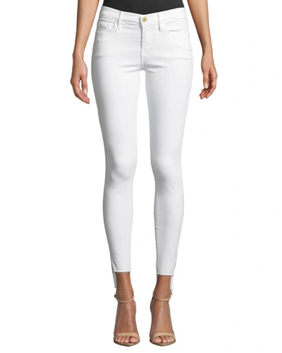 Shop Frame Le Skinny De Jeanne Mid-rise Raw Stagger-hem Jeans In Blanc