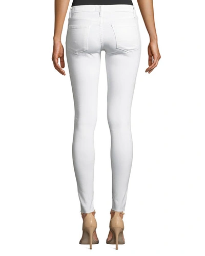 Shop Frame Le Skinny De Jeanne Mid-rise Raw Stagger-hem Jeans In Blanc