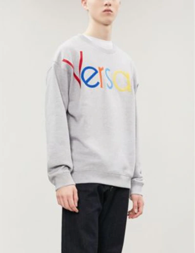 Shop Versace Logo Appliqué Cotton-jersey Sweatshirt In Grigio Chiaro