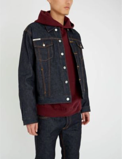 Shop Fear Of God Logo-print Denim Trucker Jacket In Raw Indigo