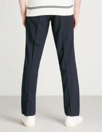 Shop Sandro Slim-fit Tapered Stretch-wool Trousers In Navy Blue