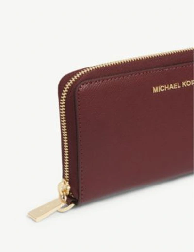 Shop Michael Michael Kors Leather Wristlet In Oxblood
