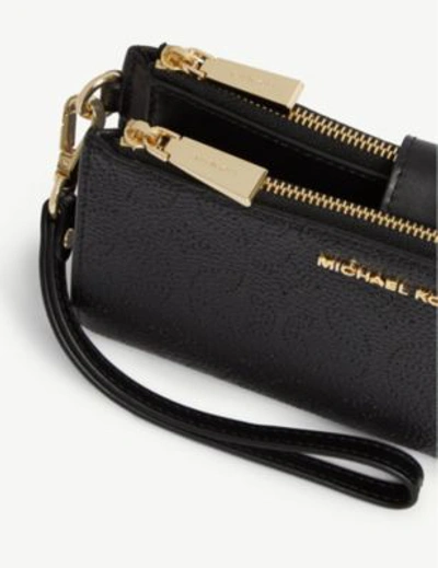 Shop Michael Michael Kors Floral Pattern Leather Wristlet In Black