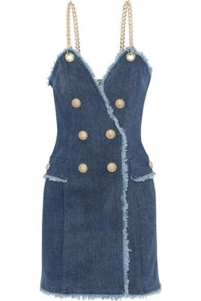 Shop Balmain Button-embellished Frayed Denim Mini Dress In Mid Denim