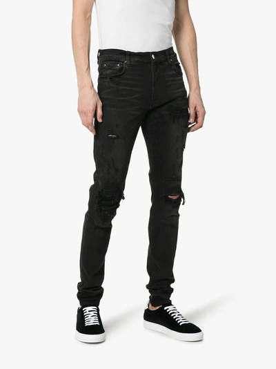 Shop Amiri Repair Distressed Slim Fit Denim Jeans In 101 - Black