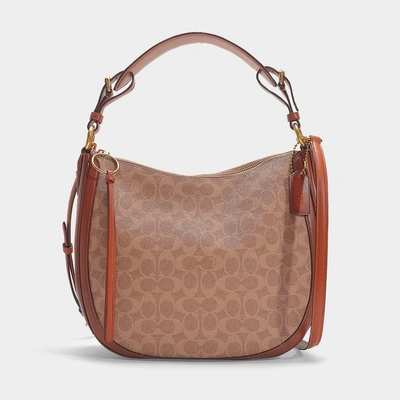 Shop Coach Coated Canvas Signature Sutton Hobo Bag In Brown Canvas