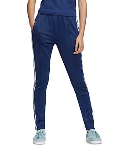 Shop Adidas Originals Sst Triple Stripe Track Pants In Dark Blue