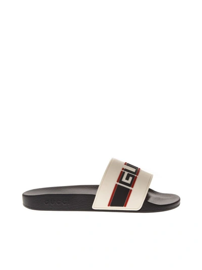 Shop Gucci Beige Rubber Slide Sandals With Embossed  Logo