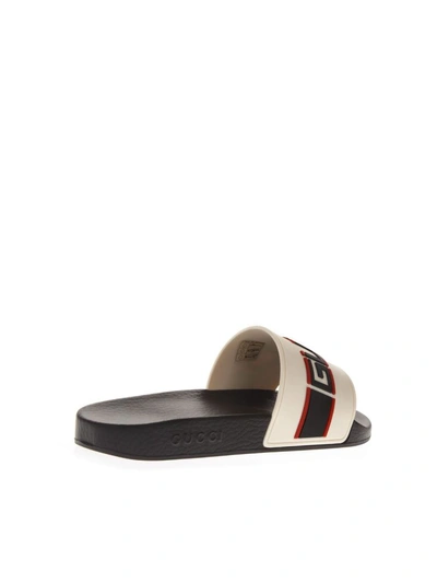 Shop Gucci Beige Rubber Slide Sandals With Embossed  Logo