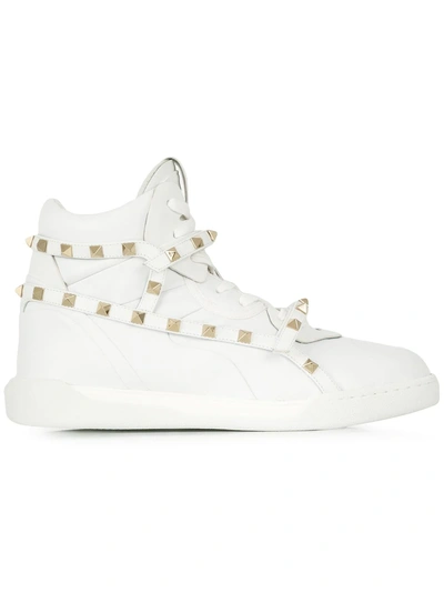 Shop Valentino Garavani Rockstud Hi-top Sneakers - White