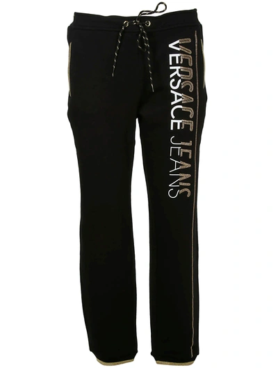 Shop Versace Logo Embellished Track Pants In Black