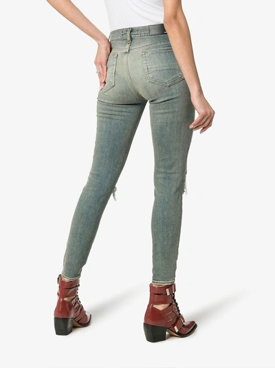 Shop Amiri Ripped Knee Skinny Jeans In Denim