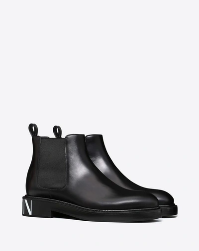 Shop Valentino Garavani Uomo Vltn Brush-off Calfskin Beatle Boots In Black