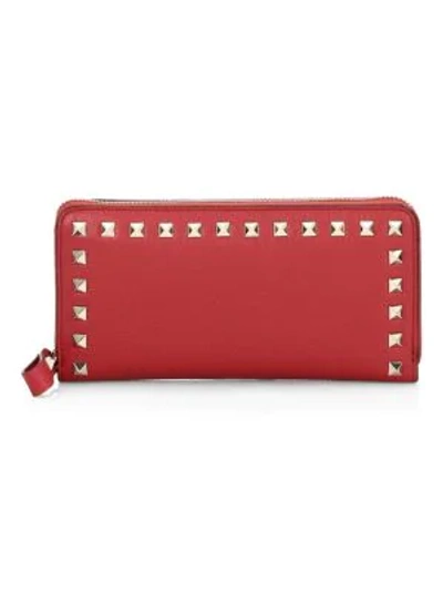 Shop Valentino Rockstud Leather Zip-around Continental Wallet In Rosso